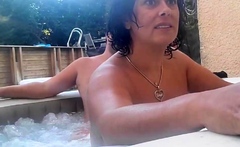 Brunette milf with large melons masturbates under shower