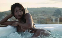 Petite Ebony MILF strips naked in a pool